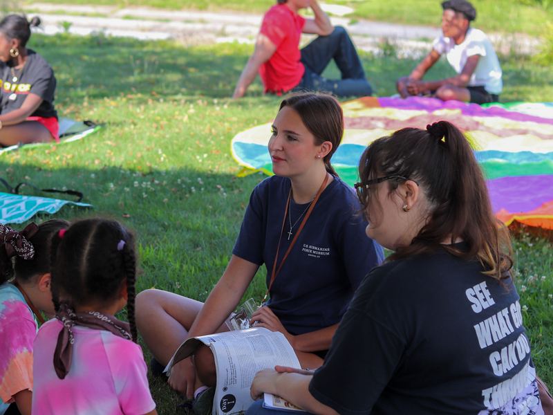 Volunteers with kids at a community outreach event