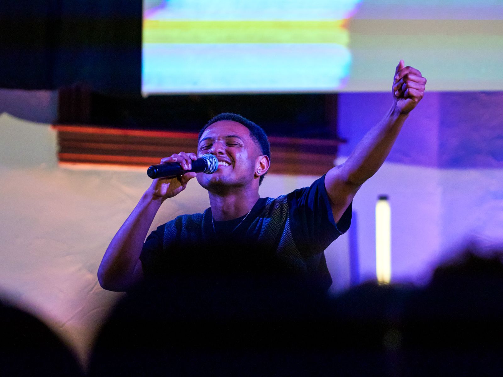 A young adult leading worship